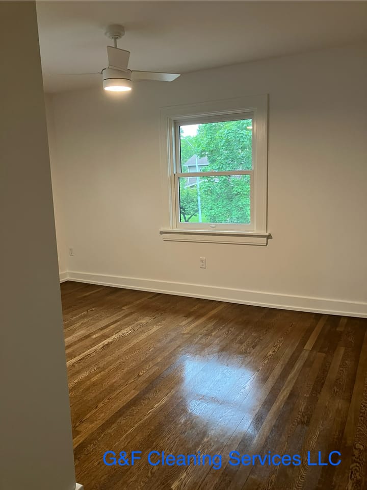 An empty room with hardwood floors cleaned to a shine