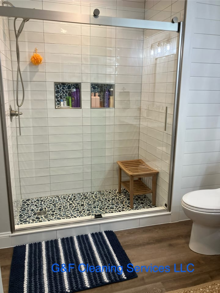 A glass walk-in shower cleaned, screen and tile clear of marks